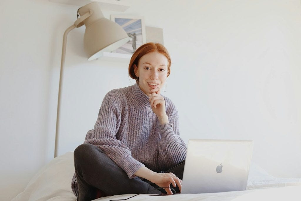 woman on laptop in bed