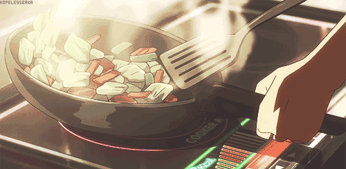This may contain: someone is cooking something in a frying pan on top of the gas burner