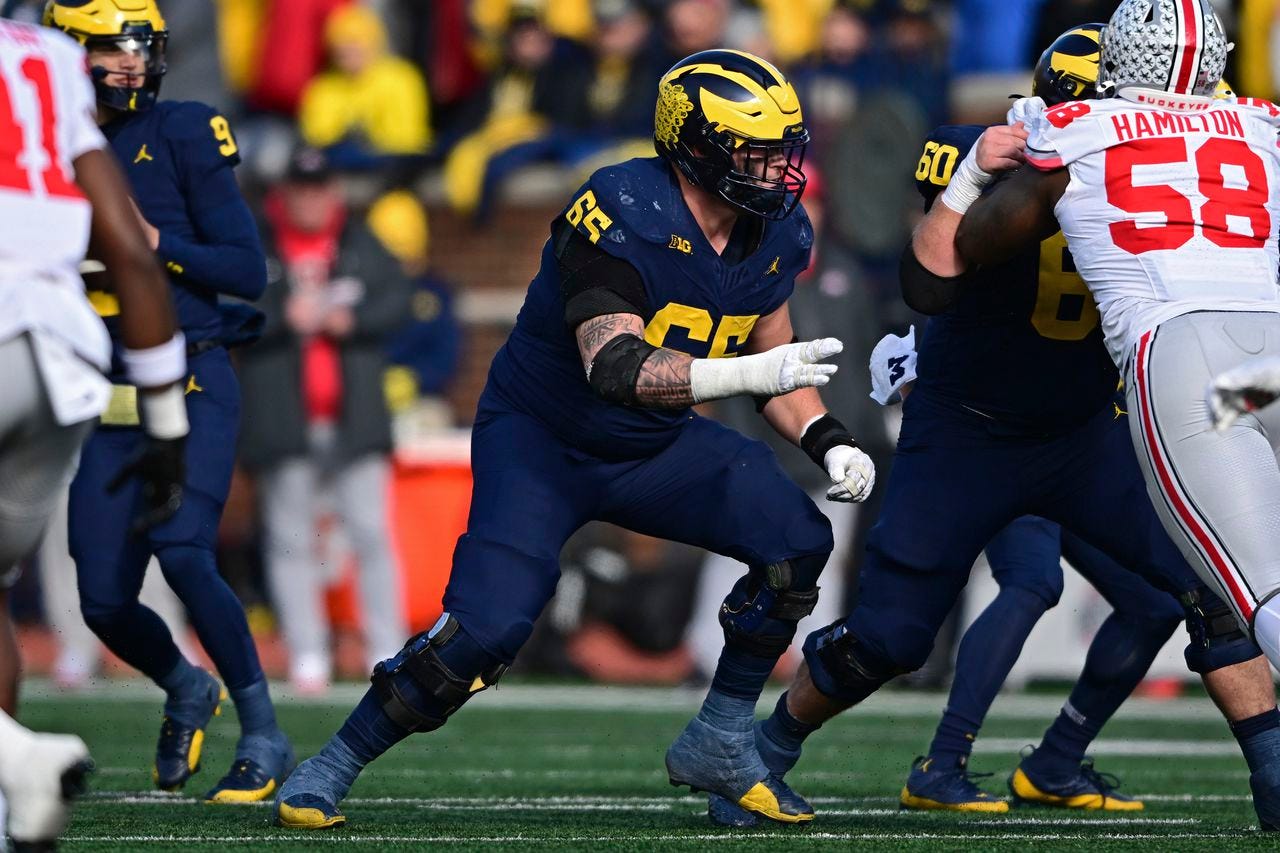 Michigan Guard Zak Zinter in action blocking for QB JJ McCarthy versus Ohio State.