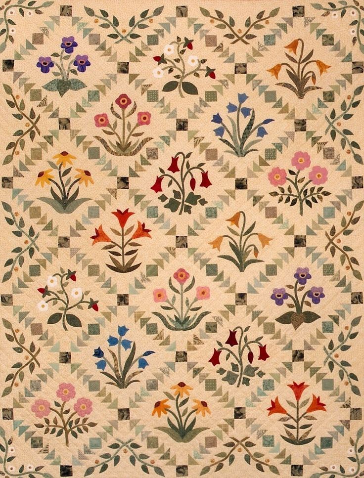 This may contain: an old quilt with flowers and leaves on the front, is shown in full color