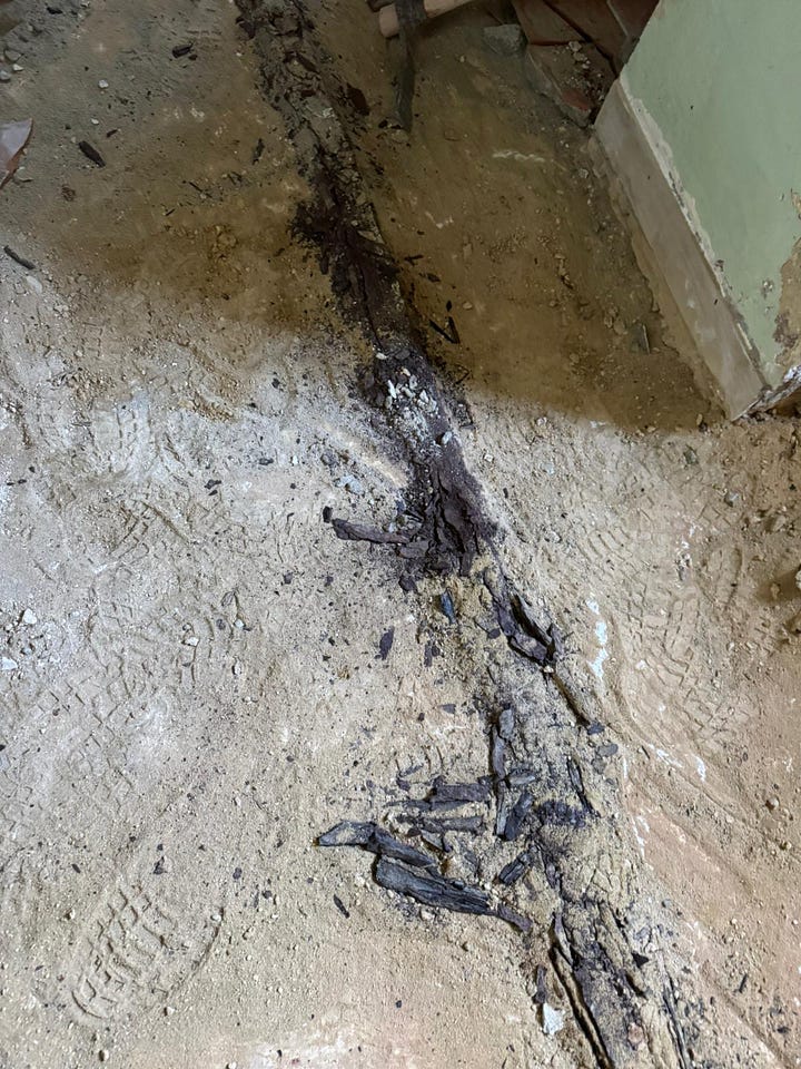 Decomposed metal struts immediately underneath the now removed metal tiles.