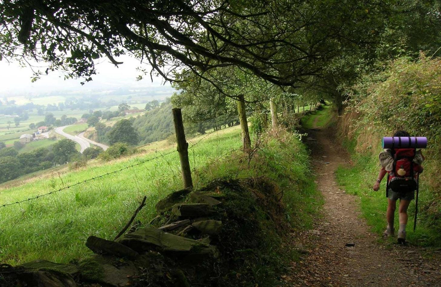 A pilgrim hiking through the mountainous landscapes of the Camino Primitivo near Oviedo, Spain. A pilgrim hiking through the mountainous landscapes of the Camino Primitivo near Oviedo, Spain.