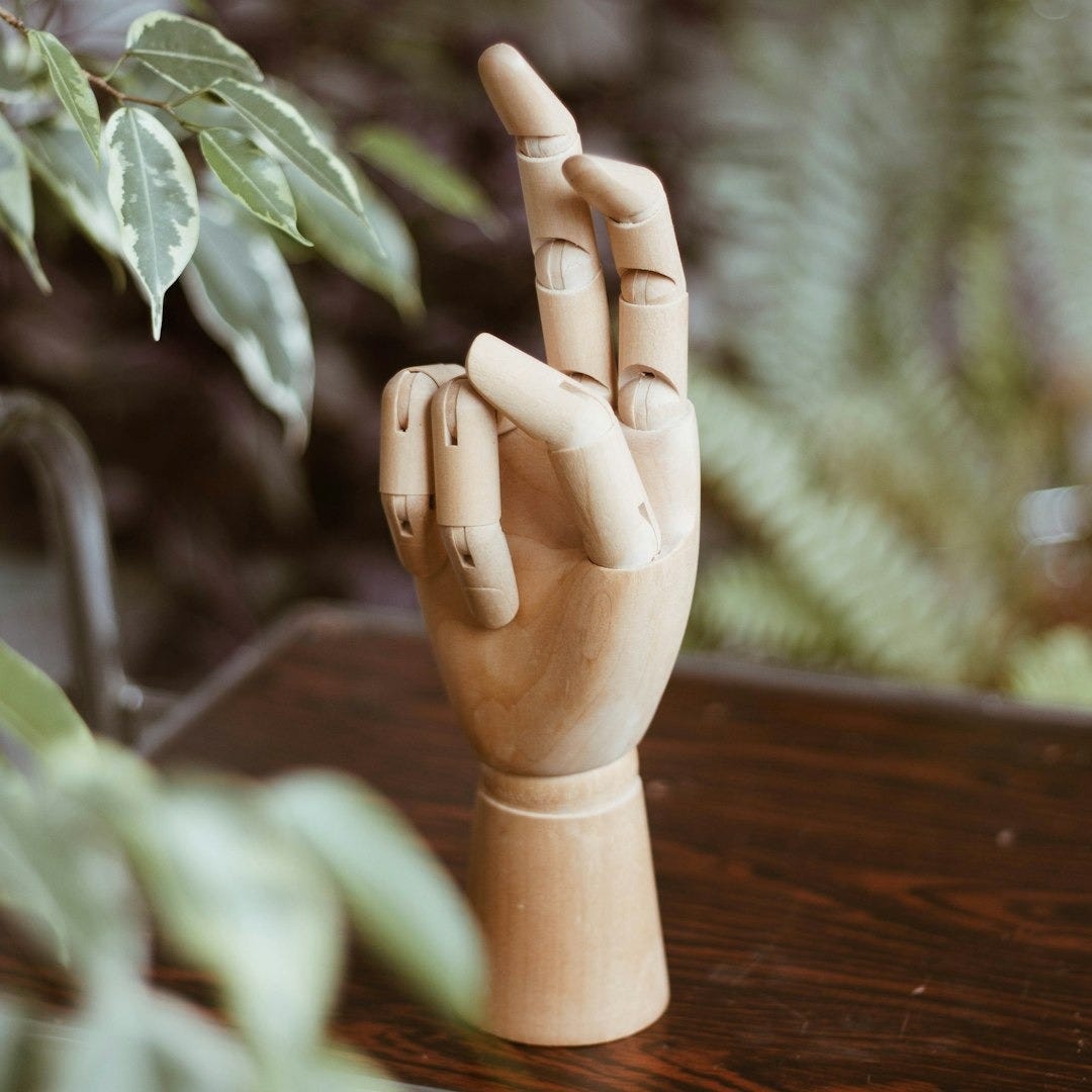 brown wooden figurine on brown wooden table