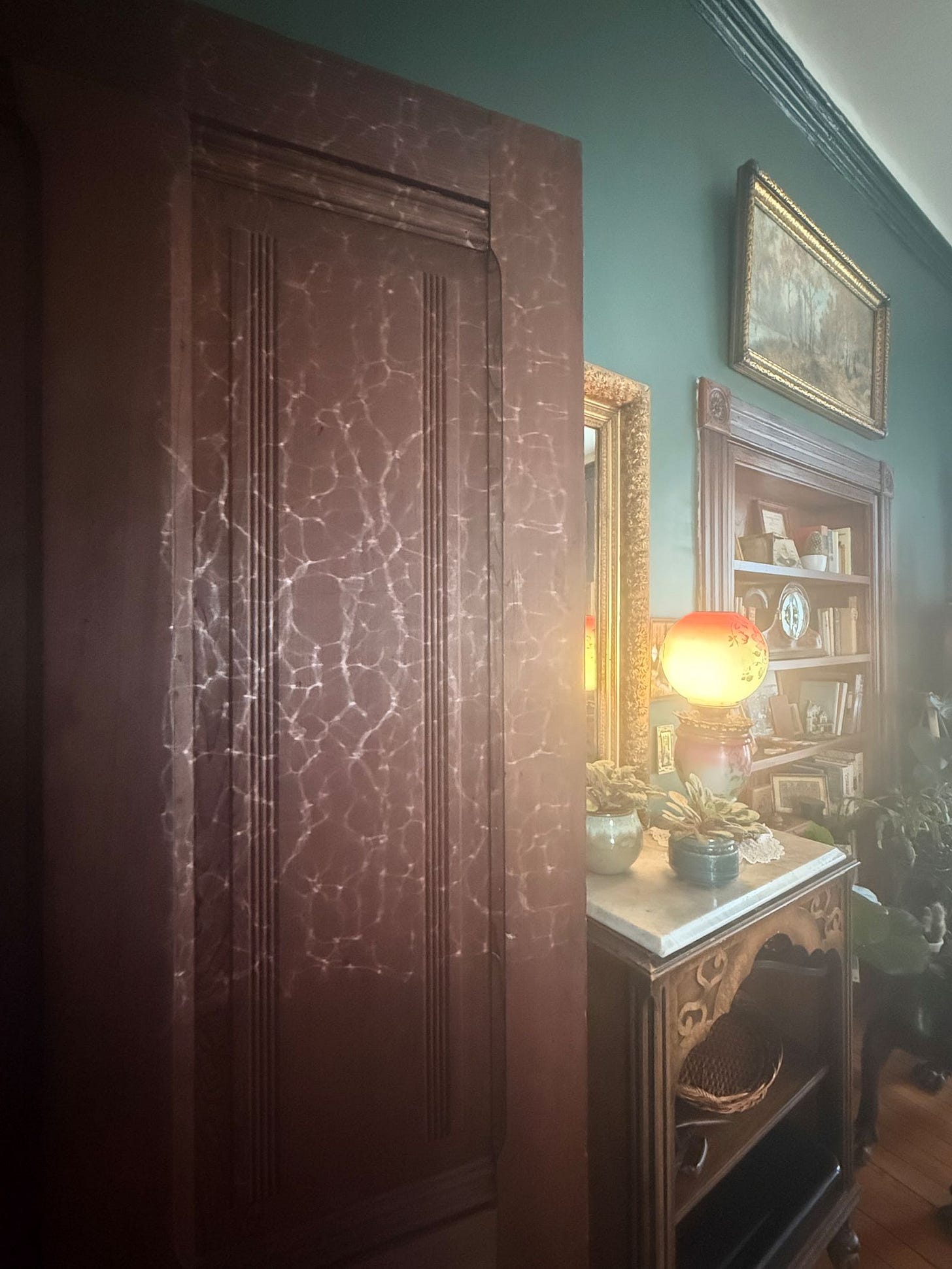 Light through antique wavy glass, cast across the dining-room door.