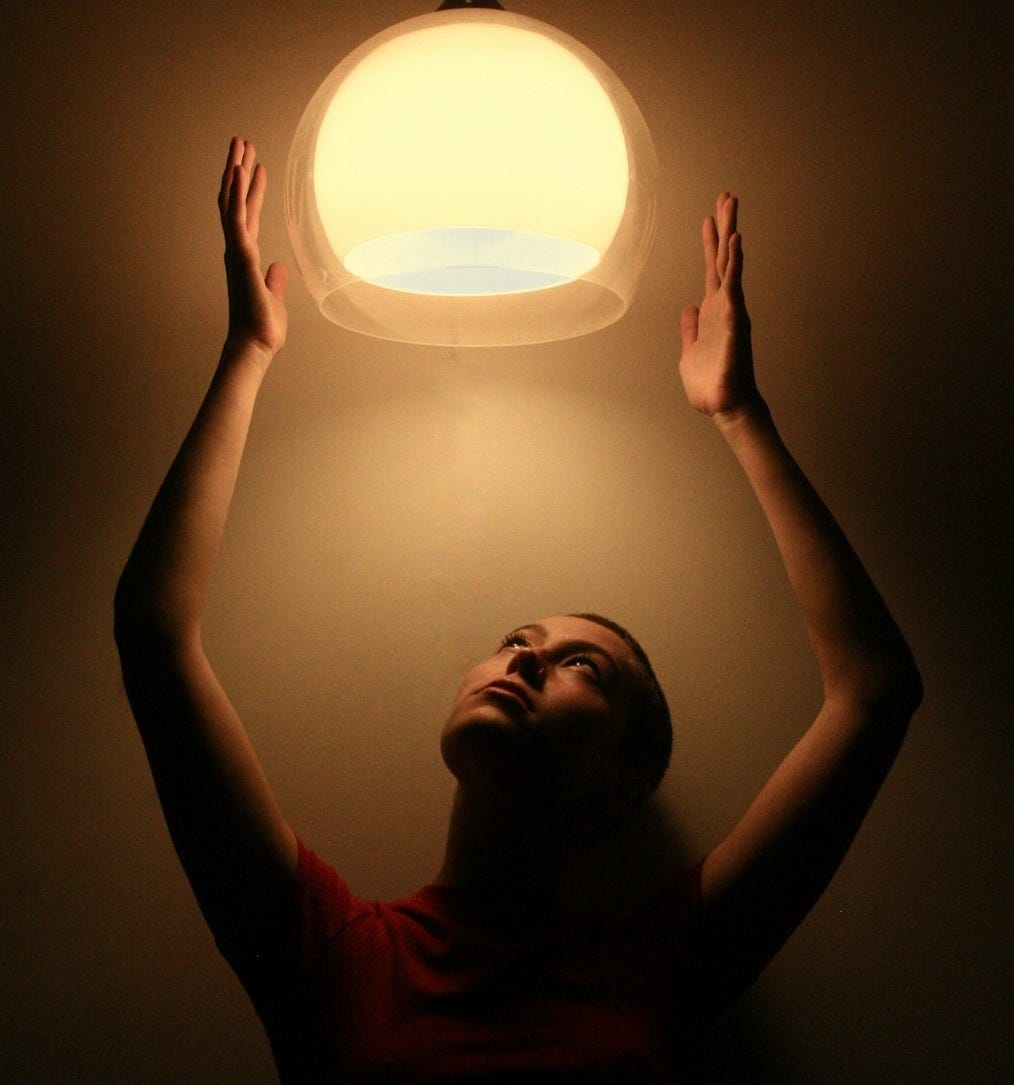 man in black tank top holding round light