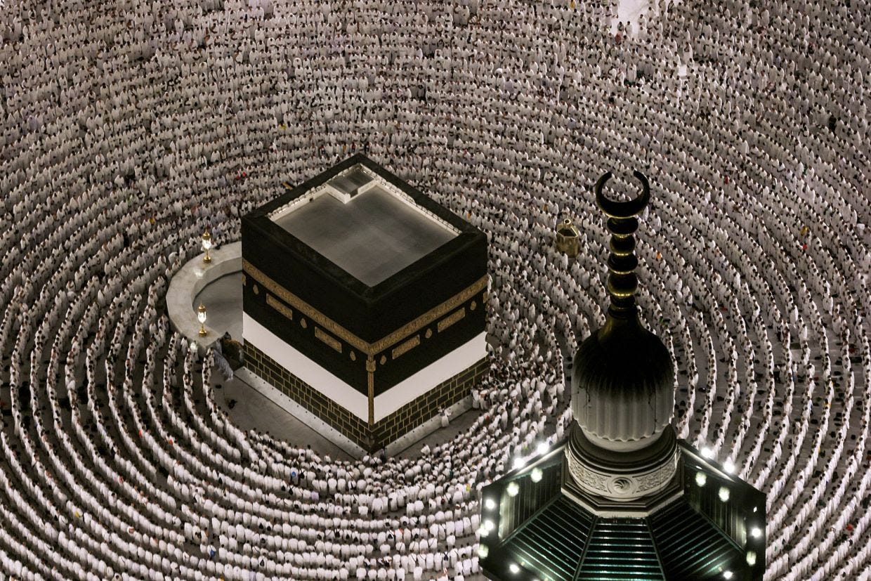 Muslim worshippers pray around the Kaaba