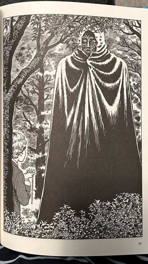 Junji Ito's Frankenstein. A large figure in a cloak hulks over a small boy.