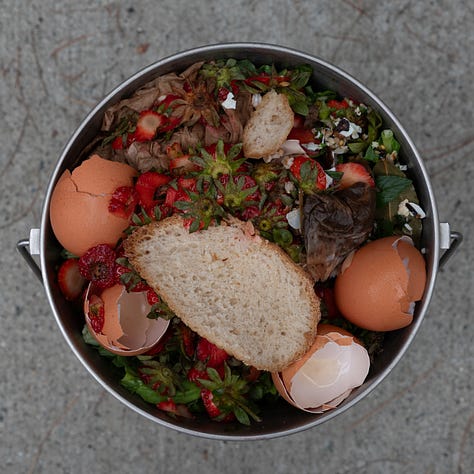 Triptych: Three compost buckets, two have strawberry tops and other stuff. The middle one has a banana peel and greens.