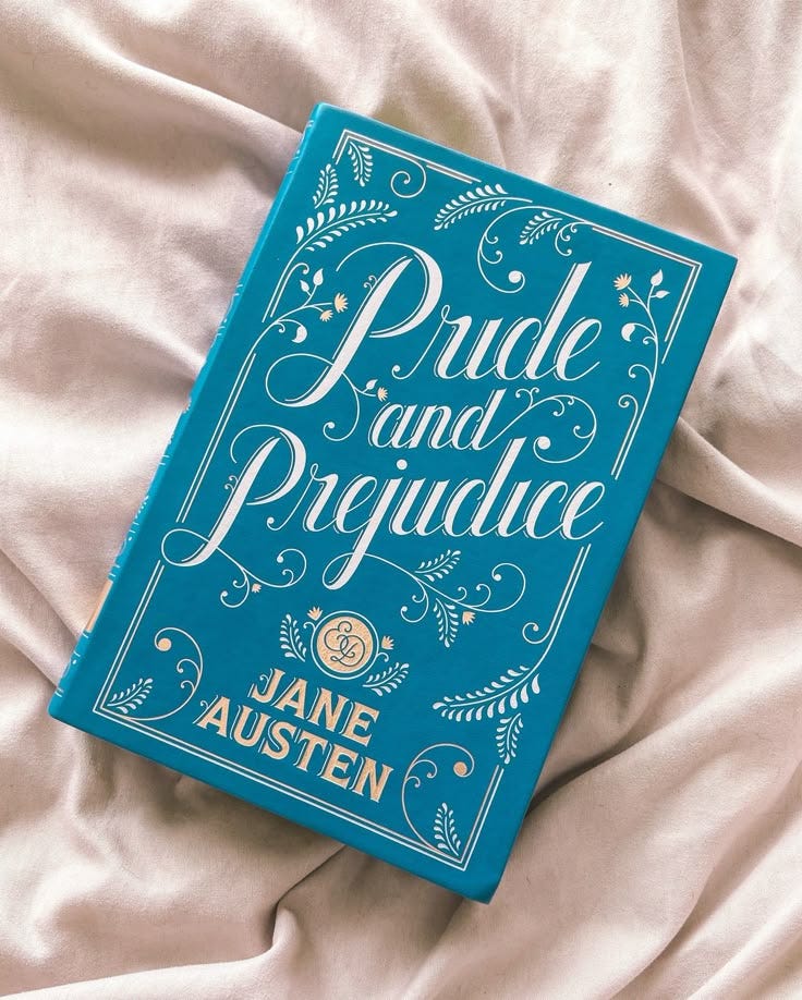 This may contain: a blue book sitting on top of a bed covered in white sheets and blankets with the title pride and providence written above it