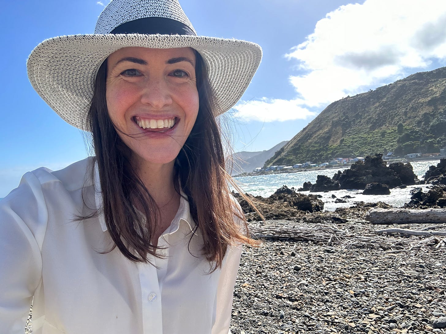 Author Helena de Bres posing next to a stunning lake on the other side of the Earth