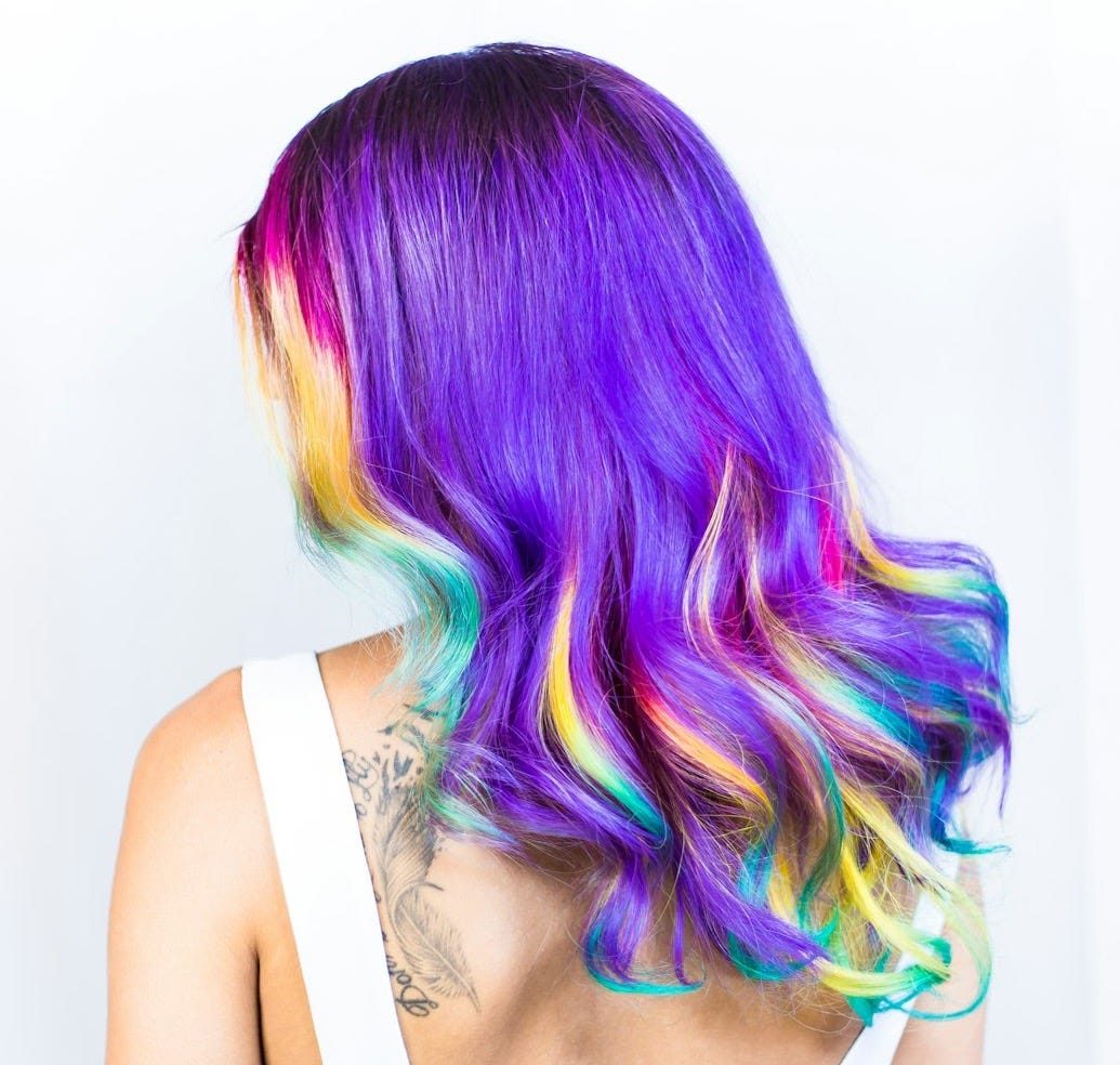 woman in white top with multicolored hairstyle