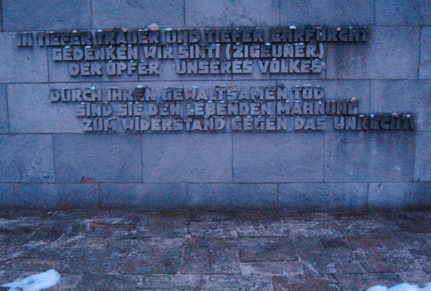 A stone wall with words carved into it

AI-generated content may be incorrect.