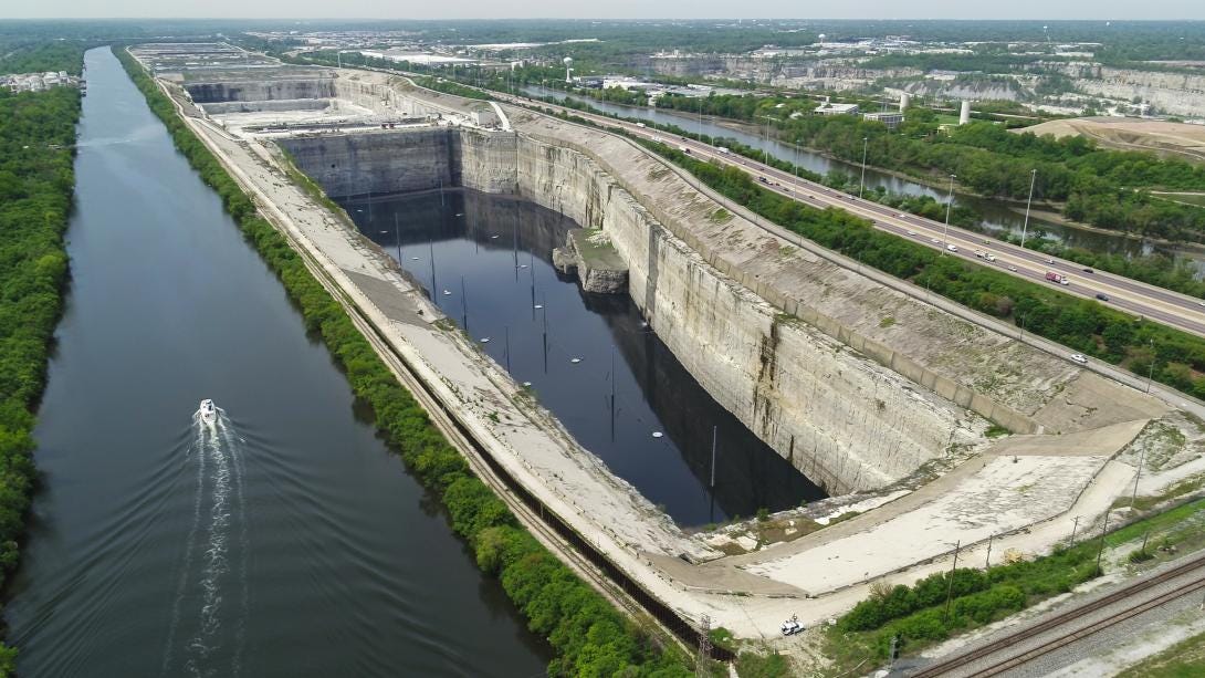 An aerial view of the McCook Reservoir with a boat passing by on the Chicago Sanitary and Ship Canal