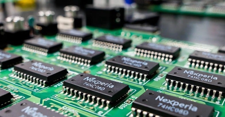 A photograph of Nexperia semiconductor chips on a circuit board in an industrial setting. A photograph of Nexperia semiconductor chips on a circuit board in an industrial setting.