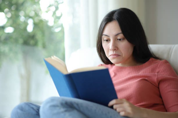 Confused asian woman reading a paper book at home Confused asian woman reading a paper book at home someone that stopped reading stock pictures, royalty-free photos & images Confused asian woman reading a paper book at home Confused asian woman reading a paper book at home someone that stopped reading stock pictures, royalty-free photos & images