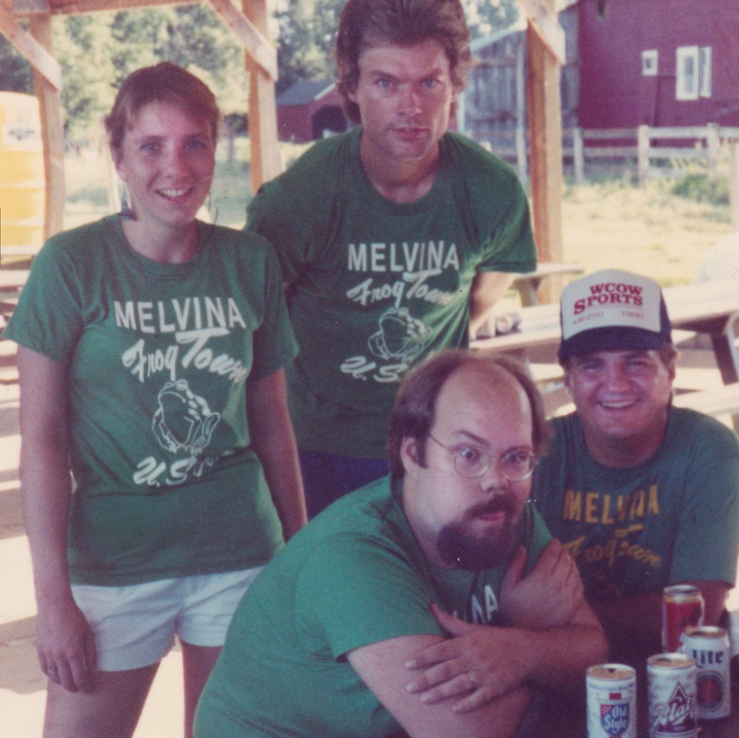 Four radio announcers wearing green Melvina Frog Town USA shirts after Frog Days