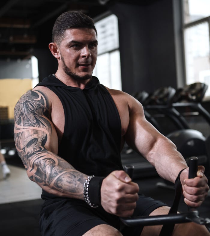 massive unit doing seated cable rows in the gym. c massive unit doing seated cable rows in the gym. c