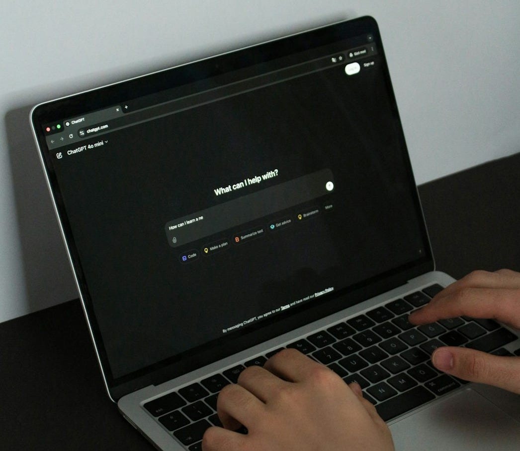 A person typing on a laptop on a table A person typing on a laptop on a table