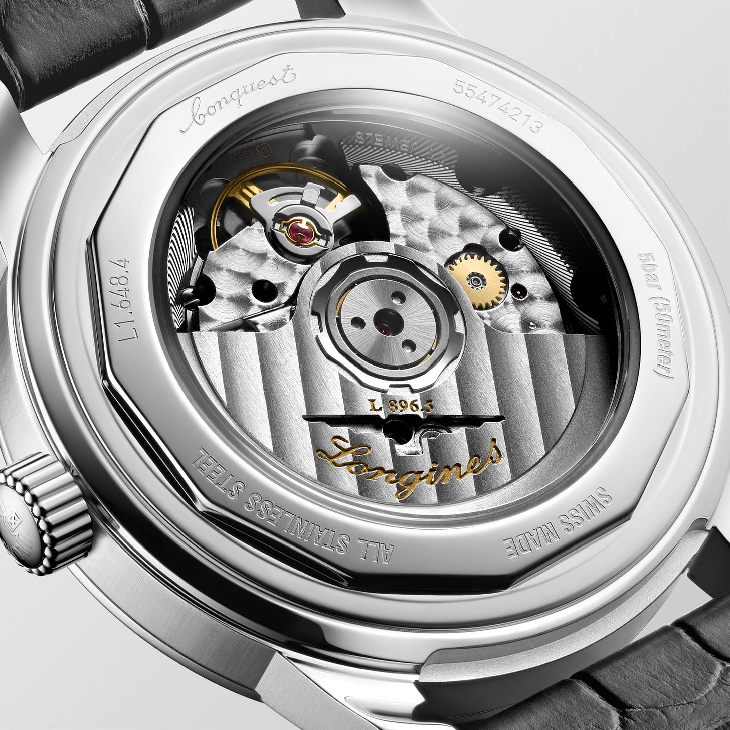 A photograph of the Longines Conquest Heritage Central Power Reserve from the caseback view, showing the exhibition caseback, automatic winding rotor with Côtes de Genève, and perlage on the main train bridge.