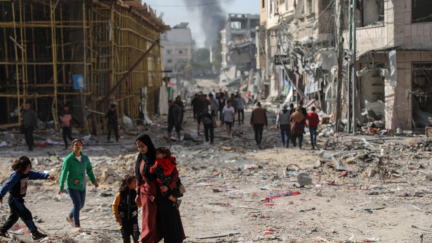 Palestinian families walk through destroyed neighbourhoods in Gaza City on 24 November 2023 as the temporary truce between Hamas and the Israeli army takes effect (MEE/Mohammed al-Hajjar)