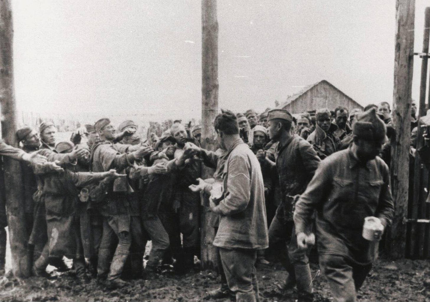 A sobering scene of bread being distributed to captured Soviet soldiers at a German prison camp in occupied Ukraine, July 1941. A sobering scene of bread being distributed to captured Soviet soldiers at a German prison camp in occupied Ukraine, July 1941.