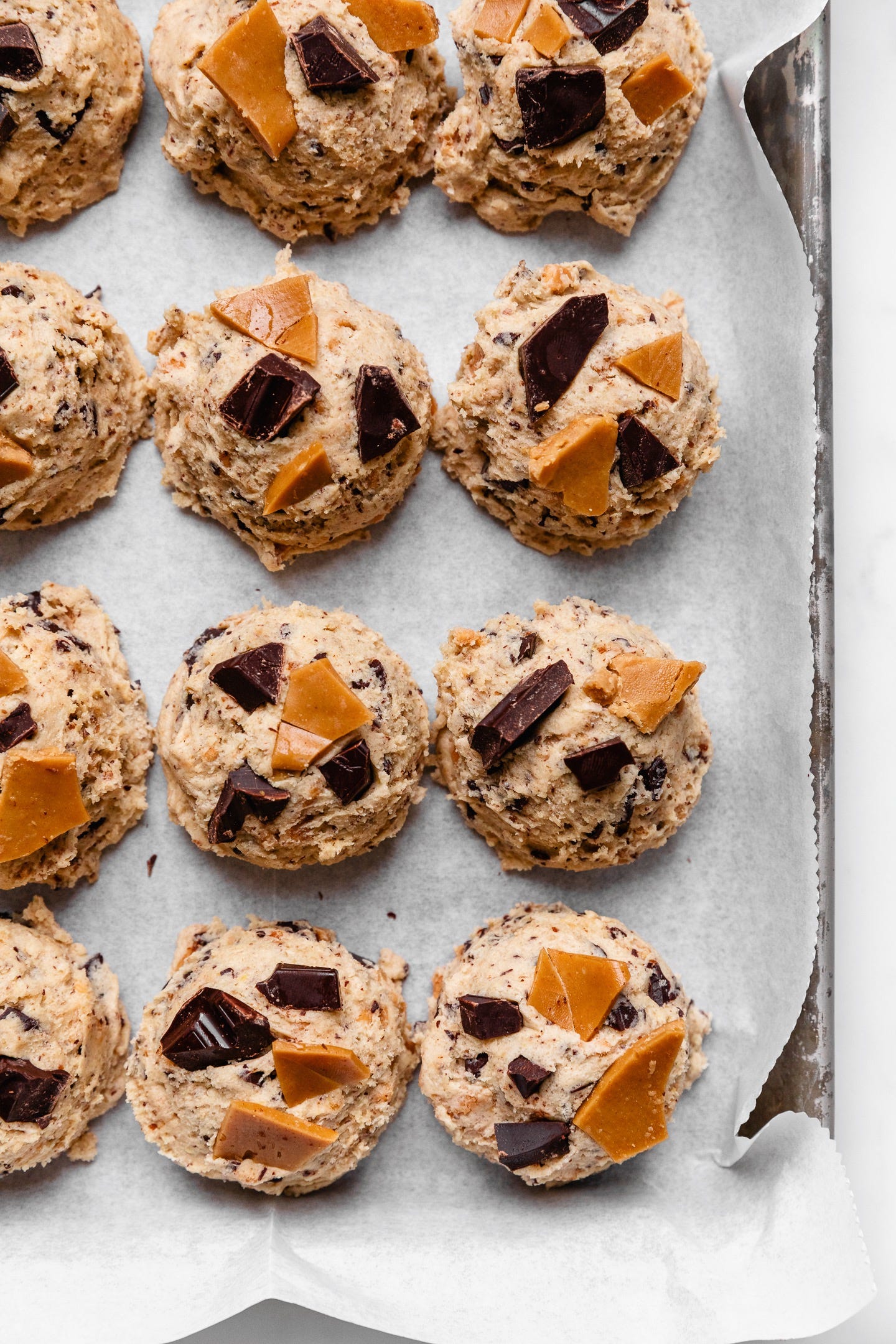 Raw dough balls of vegan toffee chocolate chunk cookies