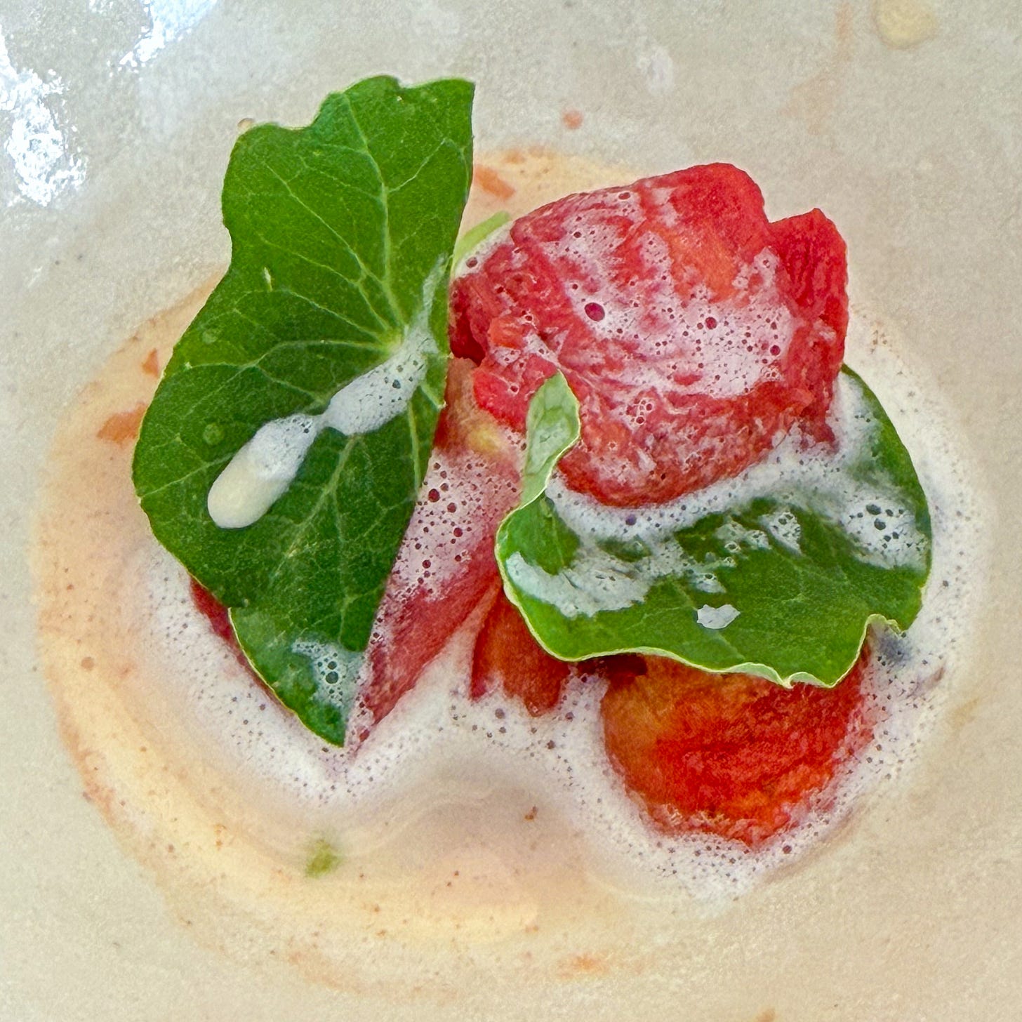 Roasted tomato with nasturtium leaves in a hogweed-seed ponzu at Bittikesu, Paris 4th Roasted tomato with nasturtium leaves in a hogweed-seed ponzu at Bittikesu, Paris 4th
