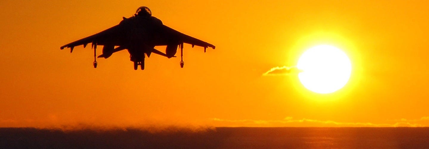 A Marine AV-8B Harrier takes off from amphibious assault ship USS Tarawa (LHA 1) just before sunset. Tarawa, along with embarked 11th Marine Expeditionary Unit, is on a scheduled deployment to the Western Pacific in support of maritime security operations and the Global War on Terrorism.