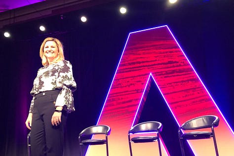 Gallery of Laurie Wetzel working at her desk, on the subway, and speaking at a conference
