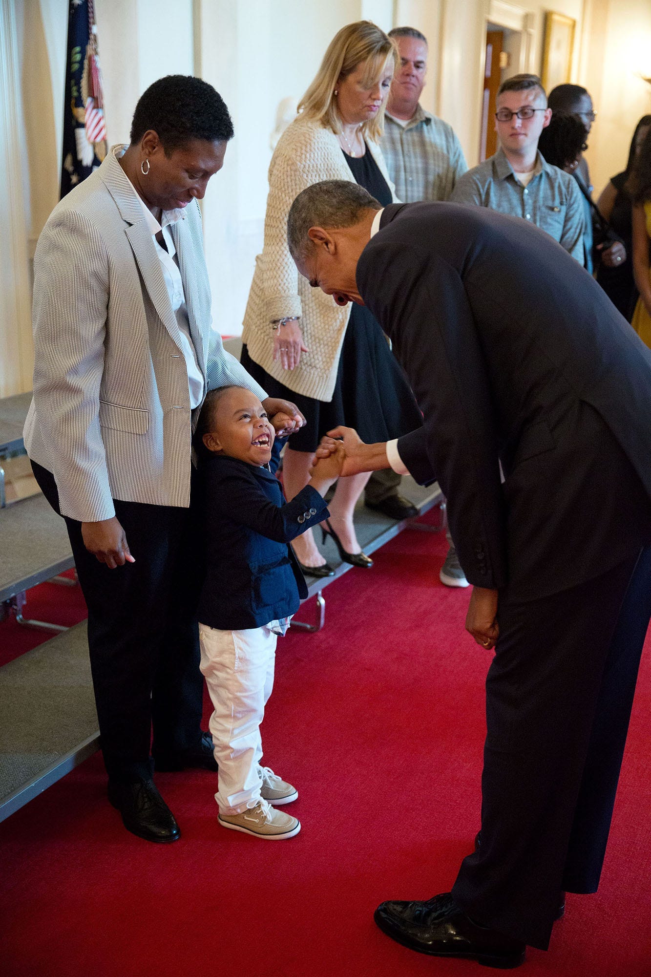 July 25, 2016: Three-year-old Armanil Chisholm reacts with delight as President Obama greets him in the Cross Hall of the White House, following a photo with wounded warriors. July 25, 2016: Three-year-old Armanil Chisholm reacts with delight as President Obama greets him in the Cross Hall of the White House, following a photo with wounded warriors.