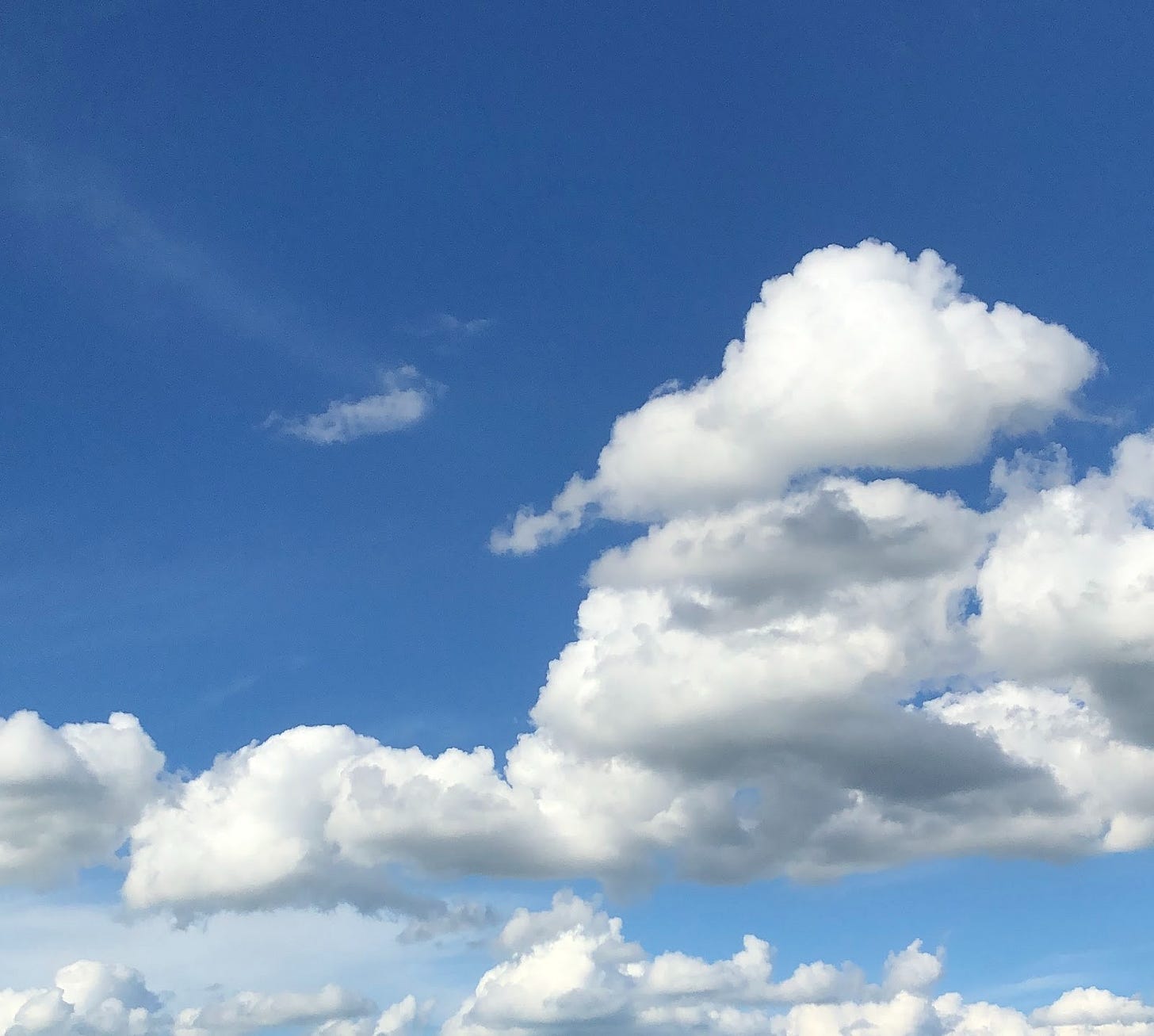 A photo of a blue sky with fluffy white clouds