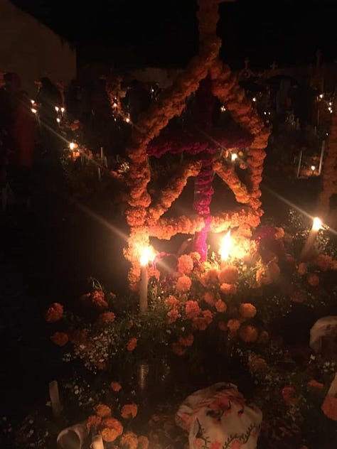 ofrendas decorated with candles, and colorful marigolds
