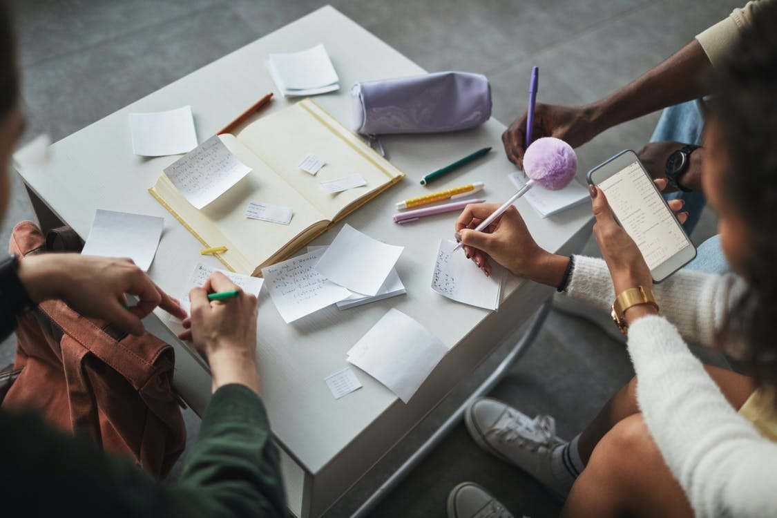Free Groups of People Writing Notes on Papers Stock Photo