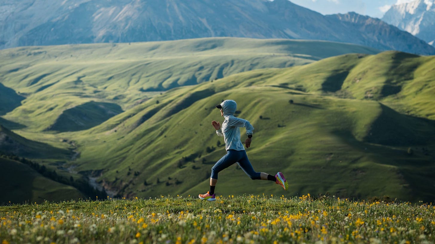 A woman trail running in the mountains. A woman trail running in the mountains.