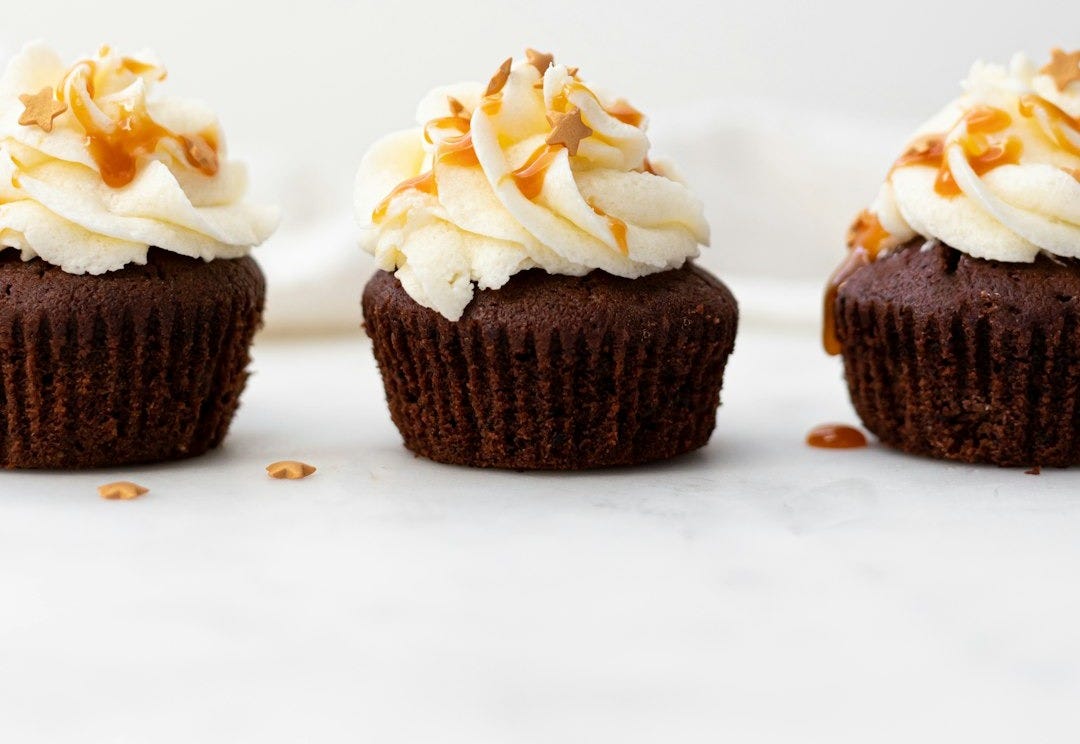 three cupcakes on white surface three cupcakes on white surface
