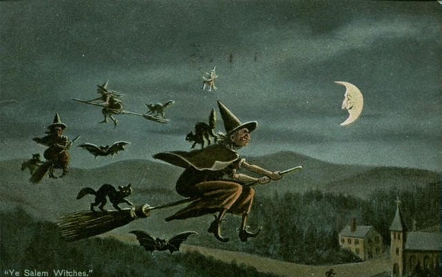 Vintage 'Salem Witches' postcard of a cartoon landscape at dusk. Women in pointed hats and black dresses fly on brooms with black cats and bats. A crescent moon has a smiling face--basically, THE WORKS