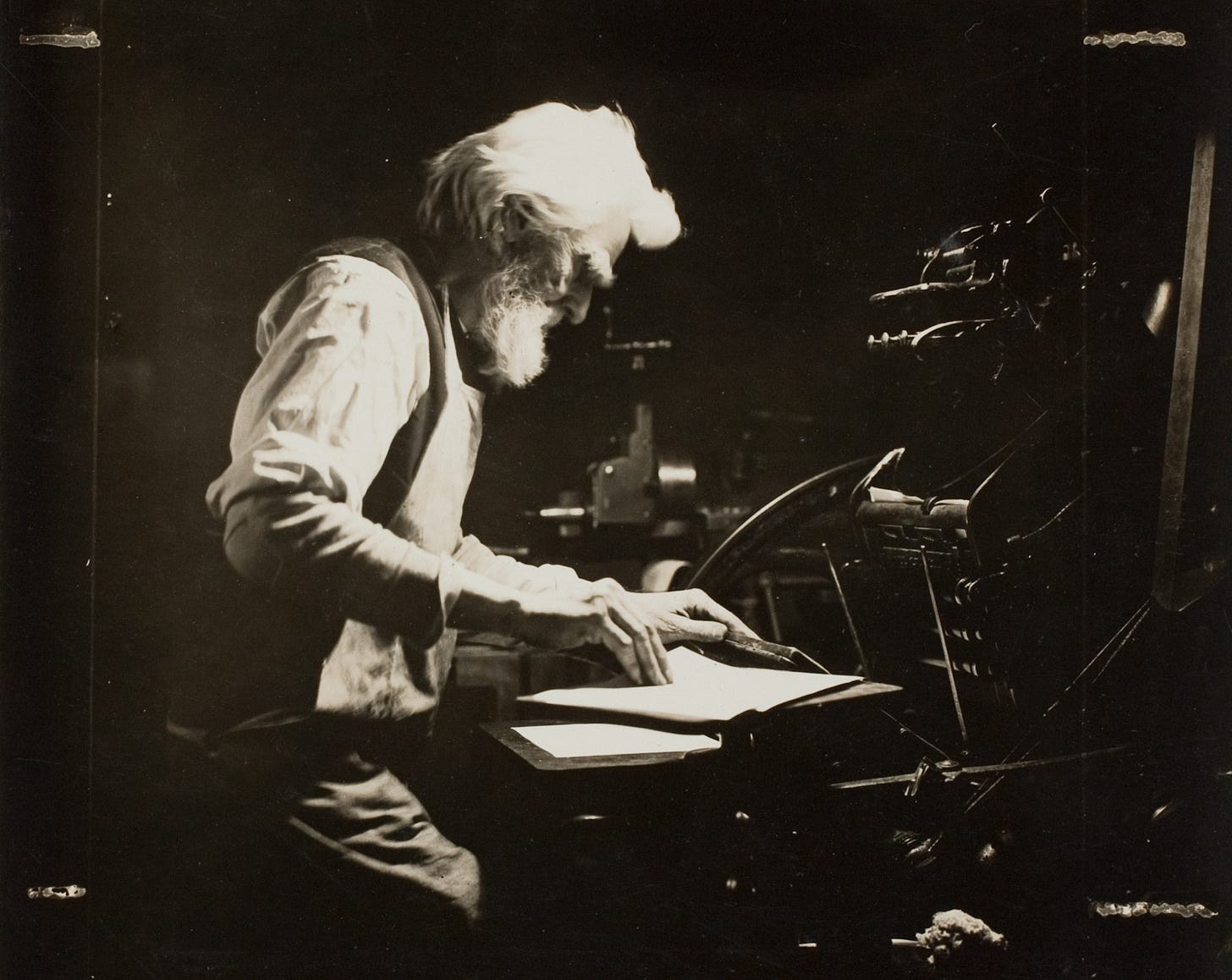 A black and white photo of a man printing.