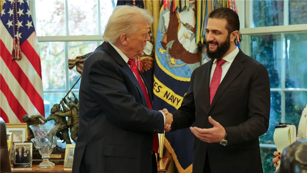 In this photo released by Syrian Presidency press office, President Donald Trump, left, shakes hands with Syria's President Ahmad al-Sharaa, at the White House