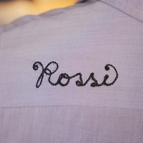 Purple bowling shirt with black embroidery showing "Mary" and "Rossi