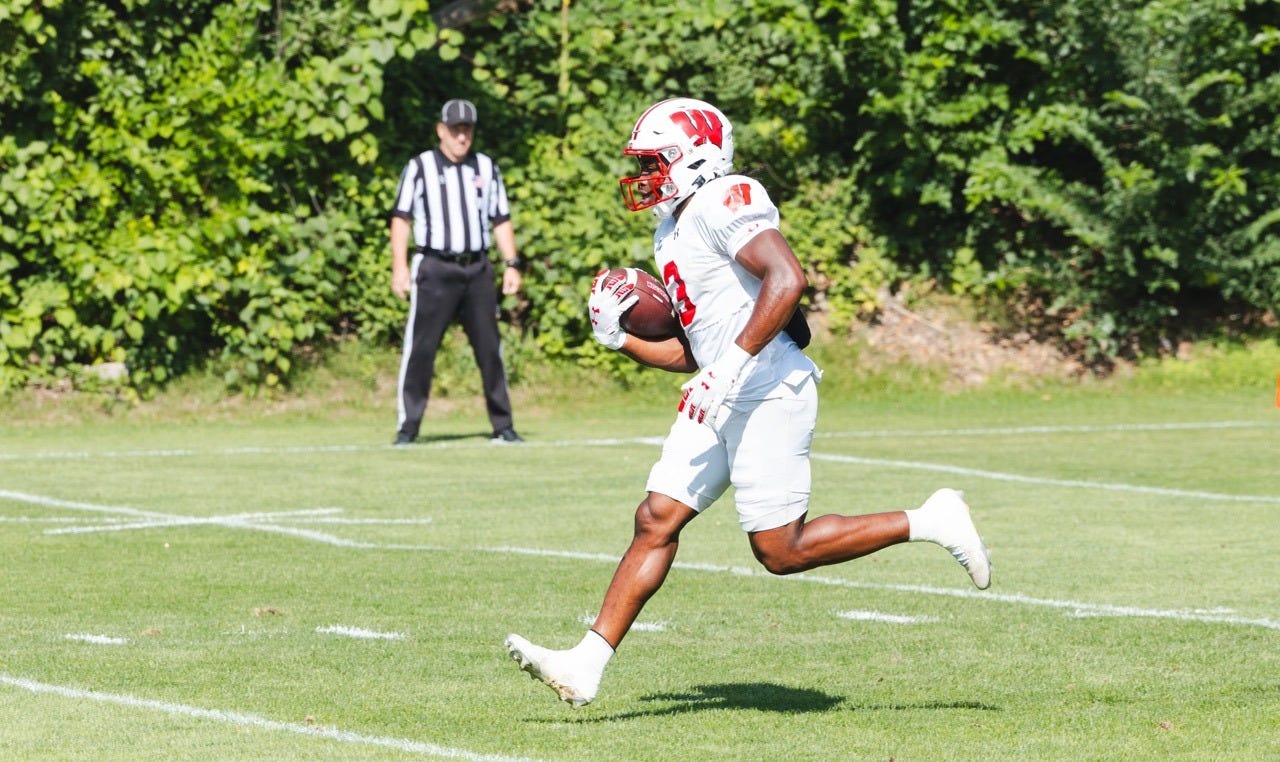 Wisconsin Badgers running back Abu Sama carries the football during an outdoor fall camp practice. Wisconsin Badgers running back Abu Sama carries the football during an outdoor fall camp practice.