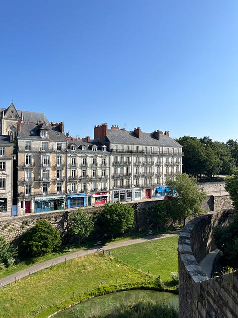 Château des Ducs de Bretagne and the city around the fortress, Jardin des Plantes, the Jean Jullien green line installation and the lively Café de l'Orangerie, former LU biscuit factory Le Lieu Unique and its bookshop and outdoor area by the river