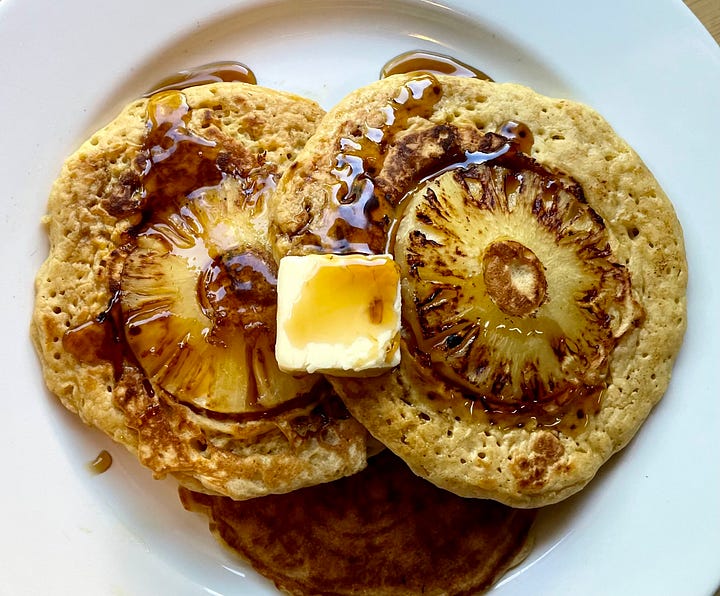 c3po's round, yellow eyes next to 2 pancakes with round yellow pineapple slices in them
