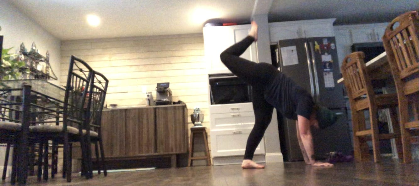 A person dances in a kitchen.