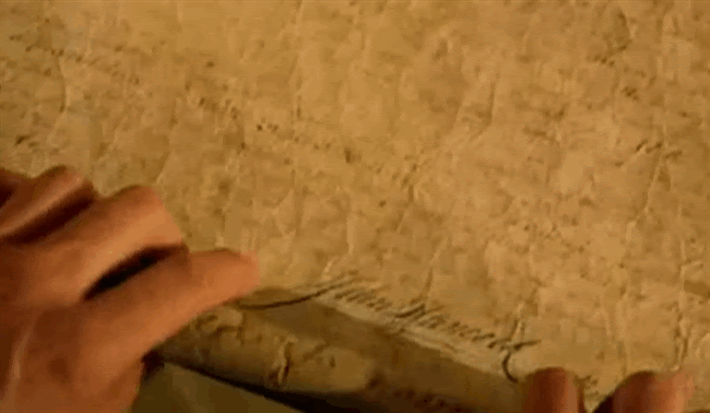 Nicholas Cage in National Treasure opening his bifocals and reading the map.