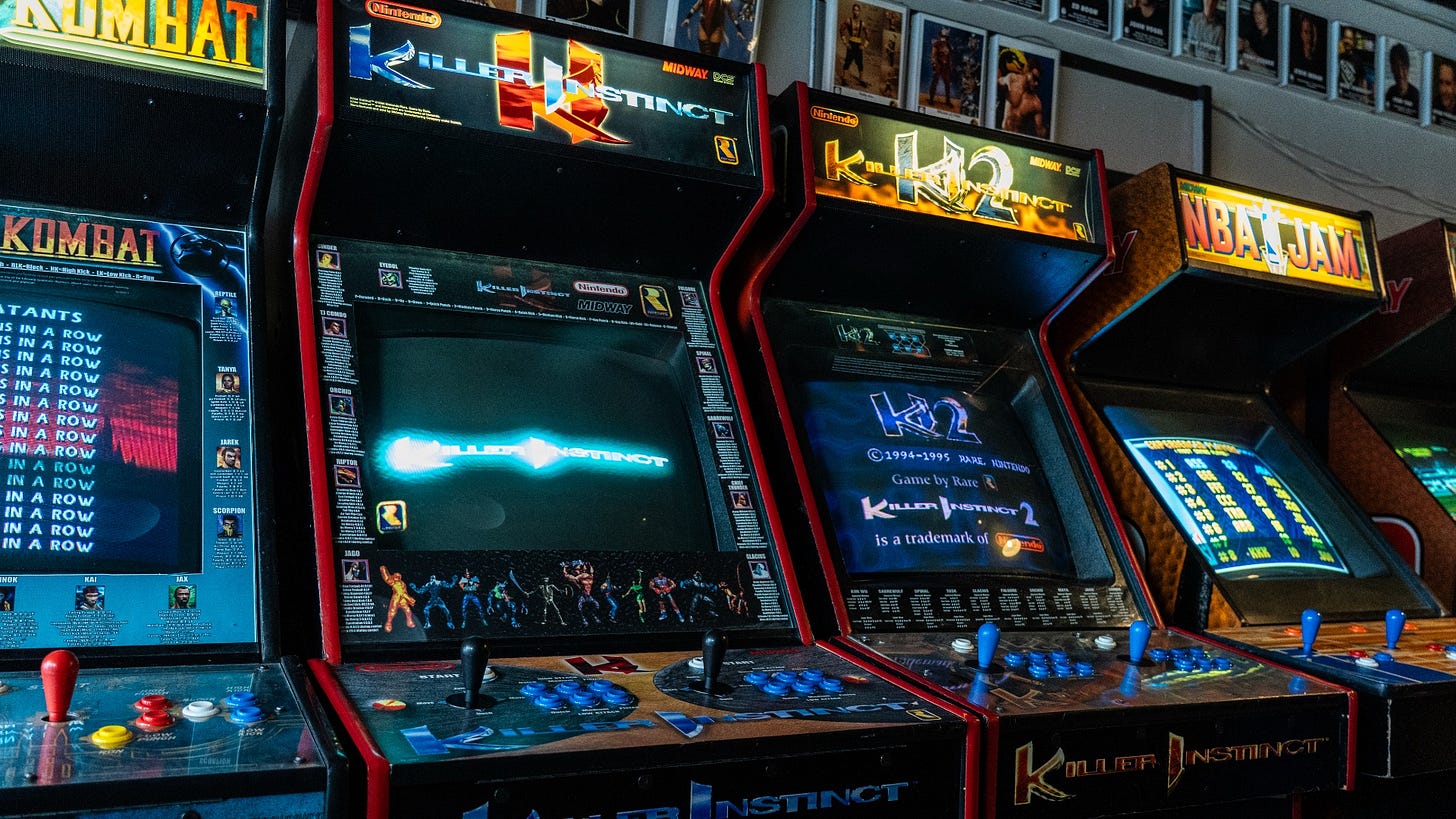 Killer Instinct arcade cabinets against a wall