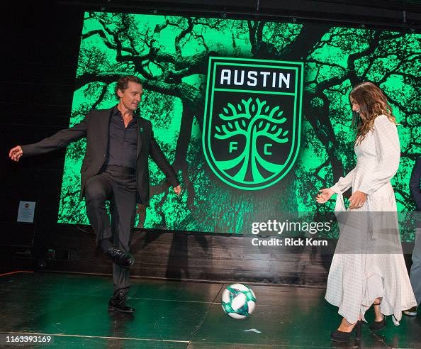 Matthew McConaughey and Camila Alves pass a soccer ball back and ...