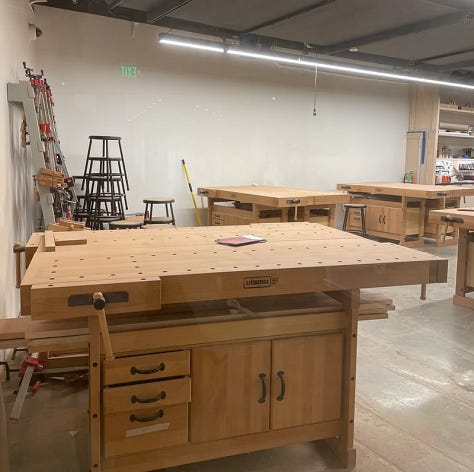 A table with a glass of wine, an art workshop, and the gift shop