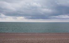 A beach under a heavily overcast sky.