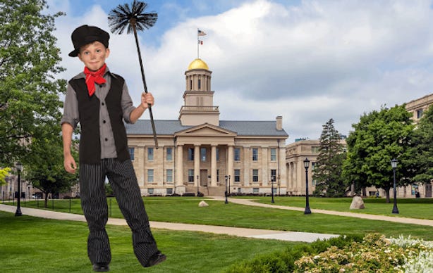 A British child in a chimney cleaner outfit standing at the University of Iowa Pentacrest.