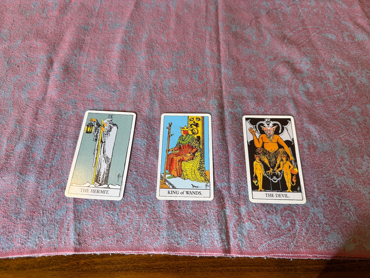 Tarot cards L to R: The Hermit, The King of Wants, The Devil